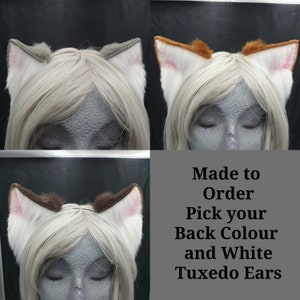 May include: Four pairs of faux fur cat ears in various colors, including gray, brown, and orange, with white tuxedo ear interiors. The ears are attached to a headband and displayed on a mannequin head with light blonde hair. Text reads "Made to Order".