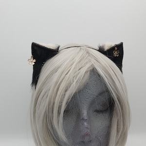 Lichtblonde en zwarte kleine kittenoorhoofdband