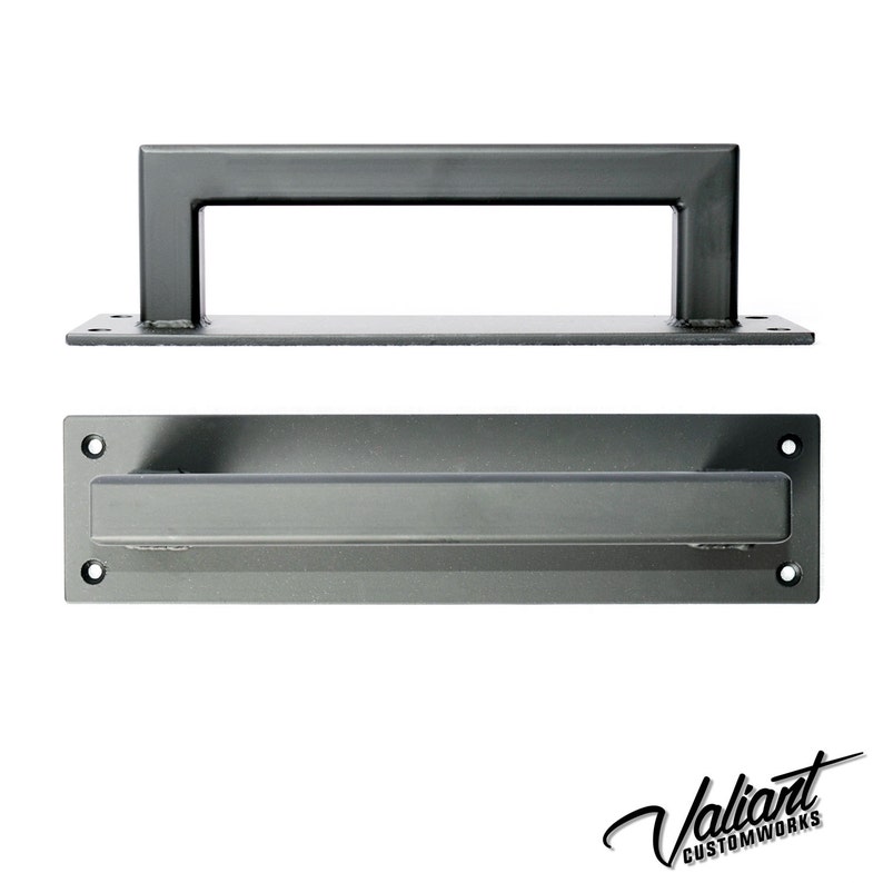 May include: Two pieces of dark gray metal hardware. The top piece is a rectangular handle with a flat base. The bottom piece is a rectangular plate with a recessed handle. The logo "Valiant Customworks" is in the bottom right corner.
