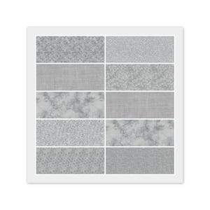 May include: A framed display of ten fabric swatches in various gray patterns. The swatches include floral, marble, and textured designs. The frame is white, and the overall aesthetic is neutral and versatile.