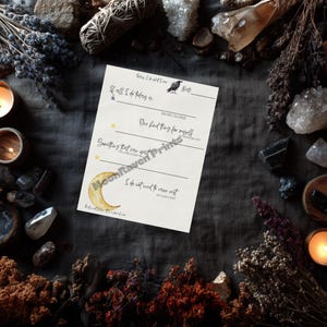 May include: A cream-colored printable daily planner with text and watercolor illustrations of a crow, moon, and stars. The planner is surrounded by crystals, candles, and dried flowers, creating a mystical aesthetic.