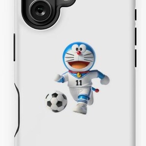 May include: White phone case featuring a cartoon character in a blue and white soccer uniform, kicking a soccer ball. The character has a blue head, red collar, and a number 11 on the uniform.