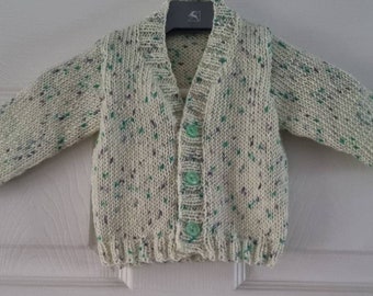 Hand knitted unisex cardigan 0 to 6 months.  Super soft feel.  Ivory with flecks of green and blue.  Newborn gift, baby shower gift