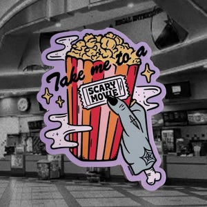 May include: A sticker featuring a popcorn bucket with the text "Take me to a Scary Movie." A zombie hand holds a movie ticket. The popcorn bucket is red, orange, and yellow. The background is a movie theater.