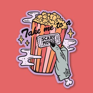 May include: A sticker featuring a cartoon image of a popcorn container with the text "Take me to a Scary Movie." A zombie hand holds a movie ticket. The design includes stars and smoke-like shapes, all set against a red background.