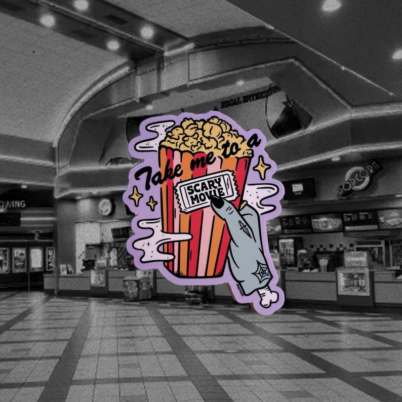 May include: A sticker featuring a popcorn bucket with the text "Take me to a Scary Movie." A zombie hand holds a movie ticket. The popcorn bucket is red, orange, and yellow. The background is a movie theater.