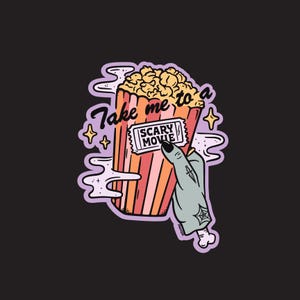 May include: A sticker featuring a cartoon image of a popcorn container with the text "Take me to a SCARY MOVIE." A zombie hand holds a movie ticket. The popcorn is yellow, and the container has red and orange stripes.