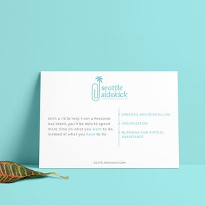 May include: A white card with the text "seattle sidekick" and a stylized paperclip with a palm tree on top. The card lists services offered: errands and scheduling, organization, and business and virtual assistance. The website address "seattlesidekick.com" is at the bottom of the card.