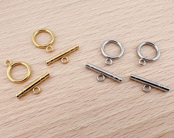 May include: Two sets of gold and silver toggle clasps for jewelry making. Each set includes two round rings and a connecting bar.