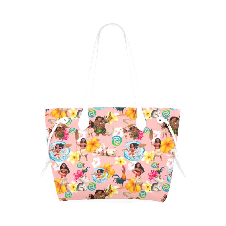 May include: A pink tote bag with white handles and a repeating pattern of characters from the animated movie Moana. The pattern includes Moana, Maui, Pua the pig, Hei Hei the rooster, and tropical flowers.