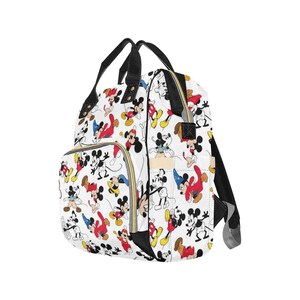 May include: A white diaper bag with a black zipper and straps. The bag is covered in a pattern of Mickey Mouse characters in various poses and colors.