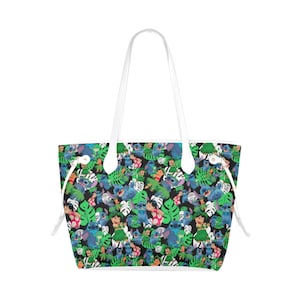 May include: A white tote bag with a black background and a repeating pattern of Stitch characters from the Disney movie Lilo & Stitch. The pattern also includes green tropical leaves.