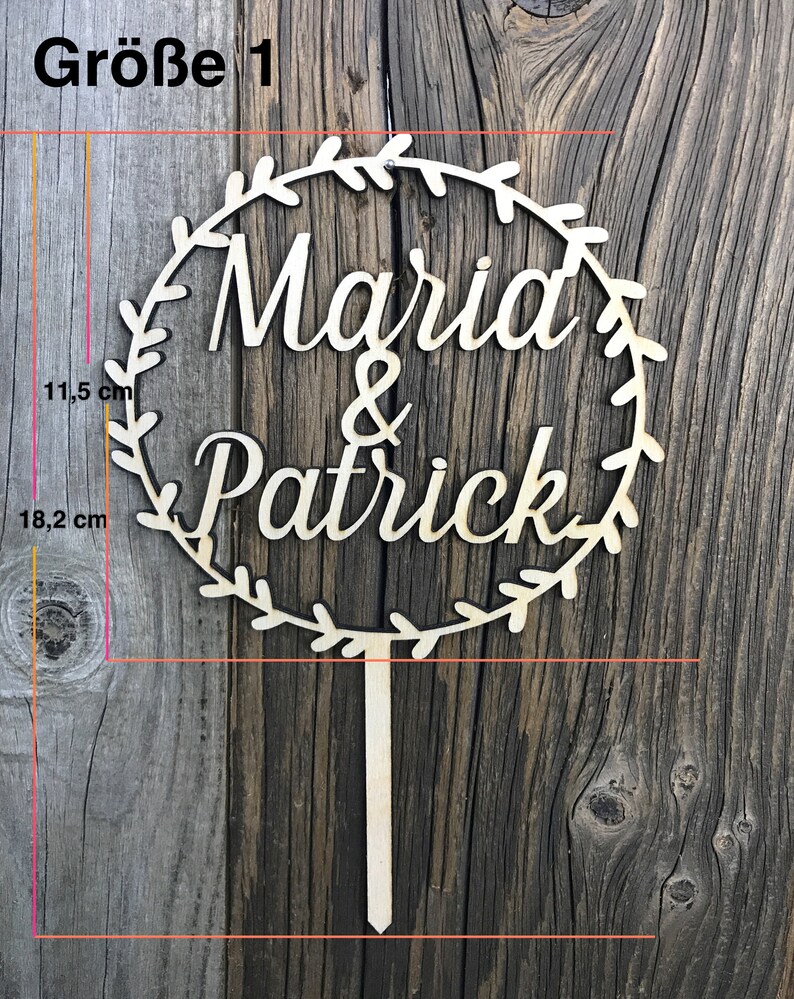 May include: Wooden cake topper with a wreath design and the names "Marid & Patrick" in cursive lettering. The topper is 18.2 inches tall and 11.5 inches wide.