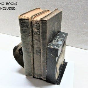PM scroll bookend features a bull, has a brass expanding spring to allow a single bookend to hold multiple books. No books included