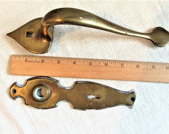 Salvaged decorative brass door hardware. Handle is 10.75" long, solid brass, door plate is 8" long. Good used condition