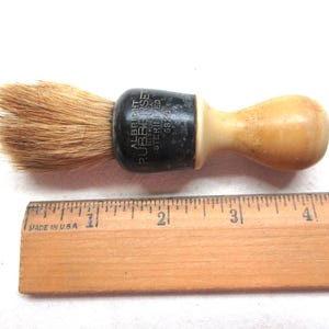 Vintage Albright 6820 Rubberset Barber Shop Shave Brush. It is 4" tall with a plastic handle. Marked Made in USA, Pure Badger