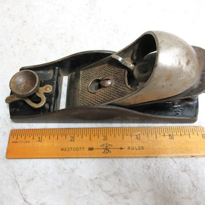 Vintage Wood Plane is 6&quot; long with a 1.5&quot; wide blade in good used condition but has some rust.