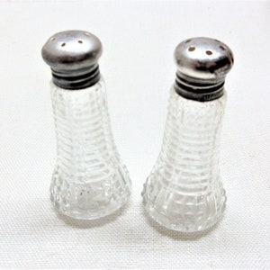 Hobnail glass salt & pepper shakers with sterling tops. Small set at only 2.5&quot; tall. Has dents in the lids