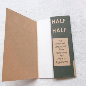 May include: A green and white paper packet with the text "HALF HALF" and "An Aromatic Blend of Fine Tobaccos for Pipe or Cigarette".