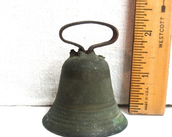 Farm animal bell. Antique rusty bell with clanger is 2.5" tall by 2" wide. It has a collar slot of 1". Makes a nice noise