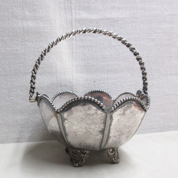 EG Webster silver plate footed basket with a rope type handle and edge. Some plate loss, tarnish and chipped edge piece. 5" wide, 2.75" tall