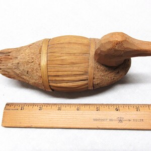 Vintage hand made duck made of straw with a wooden head. 7.5" long