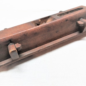 Antique wood molding plane. Missing a blade and the handle. It is about 14&quot; long. Has pegged adjustments