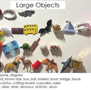 May include: An educational image featuring various small toy objects arranged with the letters a, b, c, and d. The objects include an apple, banana, carrot, car, and more. The text "Large Objects" is at the top.