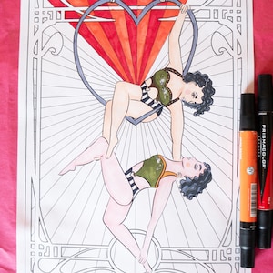 May include: A black and white line drawing of two women performing an aerial act in a heart-shaped hoop. The women are wearing leotards and are contorted in a graceful pose. The background is a stylized art deco design.