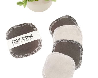 May include: Reusable facial rounds made of 100% cotton flannel. The rounds are gray with white stitching and a white center. A label reads "Facial Rounds 100% Cotton Flannel". The rounds are a sustainable alternative to disposable cotton pads.