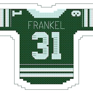 May include: A dark green jersey-shaped design with the name "FRANKEL" and the number "31" in white. The jersey has white stripes on the sleeves and bottom. The design is outlined in white.