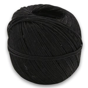 May include: A ball of black twine, a type of string made from natural fibers, is wound tightly. It is a common crafting supply.
