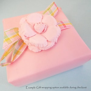 May include: Pink gift box with a pink flower and a plaid ribbon. Example Gift wrapping option available during checkout.
