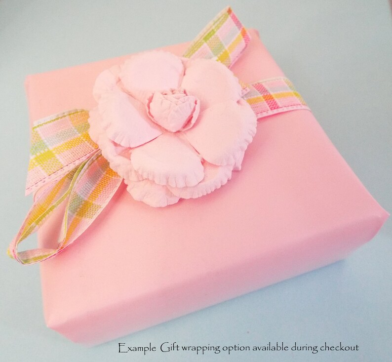 May include: Pink gift box with a pink flower and a plaid ribbon. Example Gift wrapping option available during checkout.