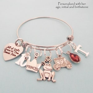 This charm bracelet has a silver finish and is available in three sizes. It will arrive with the following charms, All God's grace in one sweet face, the number 10, princess crown, frog, princess coach, your choice of initial and birthstone.