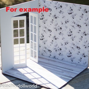 May include: A white dollhouse room with two white doors and a floral wallpaper. The floor is a light wood laminate. The text "For example" is written on the wall.