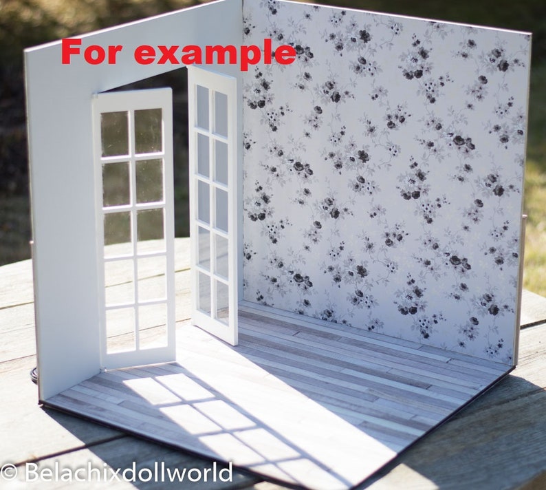 May include: A white dollhouse room with two white doors and a floral wallpaper. The floor is a light wood laminate. The text "For example" is written on the wall.