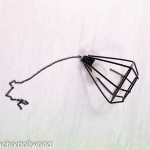 May include: Black metal cage pendant light with a chain.