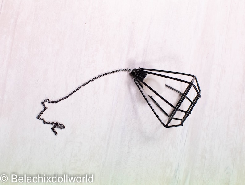 May include: Black metal cage pendant light with a chain.