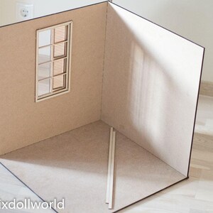 May include: A miniature room made of cardboard with a window and a wooden floor. The room is empty and ready for decorating.