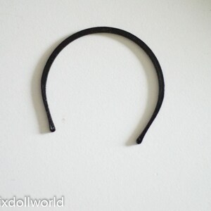May include: A black headband for hair.