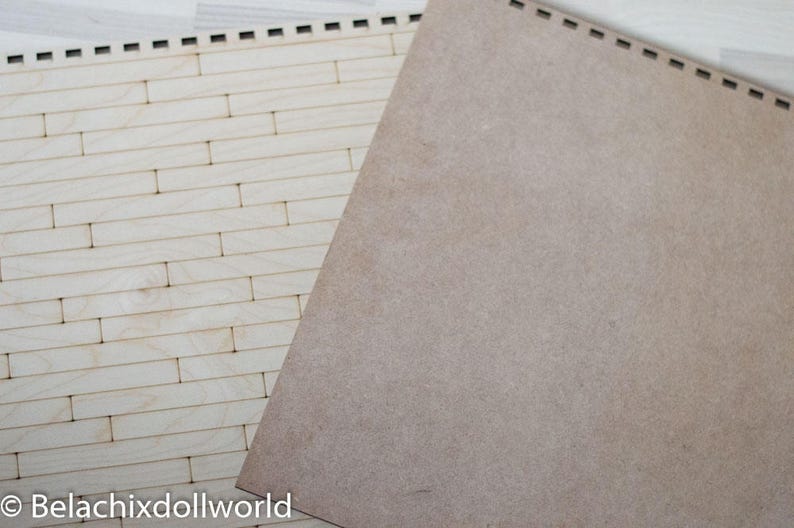 May include: A sheet of light brown craft paper with a woodgrain texture, placed on top of a sheet of white wood with a brick pattern.
