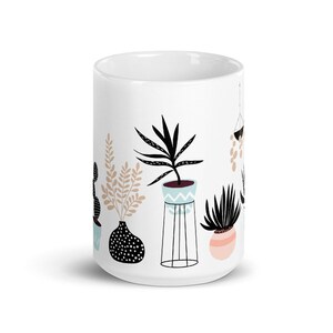 May include: White ceramic mug with a black and white illustration of potted plants. The plants are in various styles, including a cactus, a fern, and a hanging plant. The mug is a great gift for plant lovers.