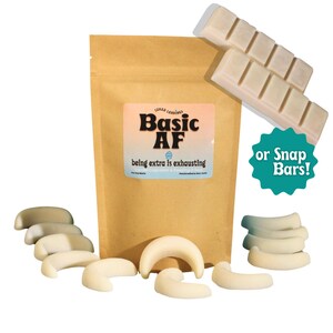 May include: A brown paper bag with a white label that says "Basic AF" and "being extra is exhausting". The bag contains white chocolate snap bars. The image also shows a white starburst-shaped sticker with the text "or Snap Bars!" in teal.