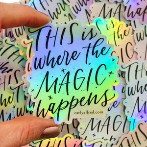 May include: A holographic sticker with the text "THIS is where the MAGIC happens" in black script. The sticker has a rainbow gradient background.