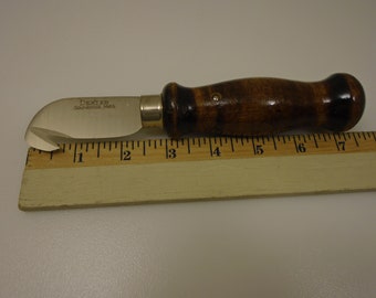 May include: A small, silver,  utility knife with a rounded blade and a wooden handle. The knife is 3 inches long and has the words "Dexter, Southbridge, Mass." engraved on the blade.