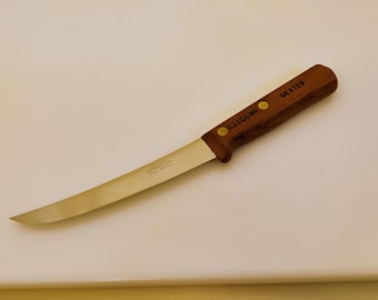 May include: A Dexter boning knife with a wooden handle and a stainless steel blade. The handle is marked with the word "DEXTER" and the number "531G6WR". The blade is curved and sharp.