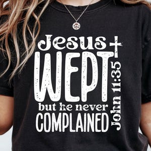 May include: Black t-shirt with the text "Jesus wept but he never complained" in white. The words "John 11:35" are printed vertically on the right side. The words "DIGITAL DESIGN" and "PNG FILE" are printed at the top left.
