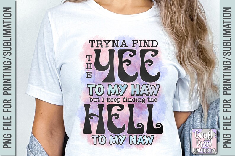 May include: White t-shirt with the text "Tryna Find The Yee To My Haw but I keep finding the Hell To My Naw" in a black, retro font. The text is set against a watercolor-style background with pink and blue hues.