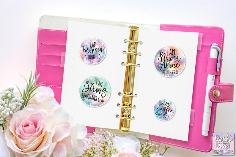 May include: Four colorful round stickers with inspirational quotes and bible verses. The stickers feature a watercolor background with a white border. The quotes are "I am Forgiven 1 John 1:9", "I am Never Alone Matthew 28:20", "I am Strong Ephesians 6:10", and "I am Safe Psalm 91:2".